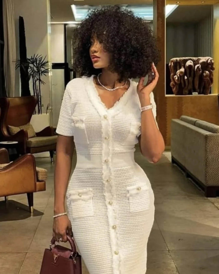 Woman in a cream button-front knitted dress with the hem falling below the knee